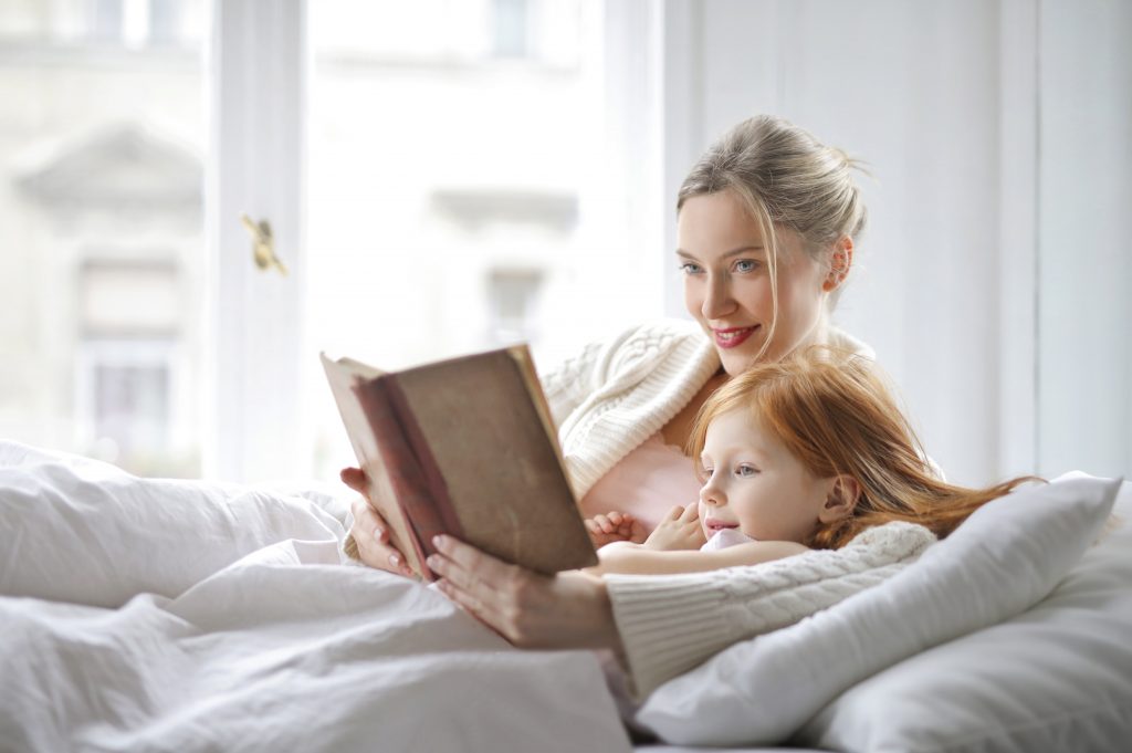 Calm parenting with daughter reading book