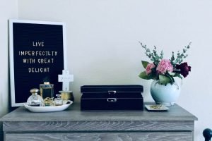 Image of Desktop with a plaque saying Live Imperfectly with Great Delight